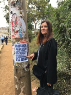 Professor Sonia Harmand with a typical Nairobi 'psychic' poster