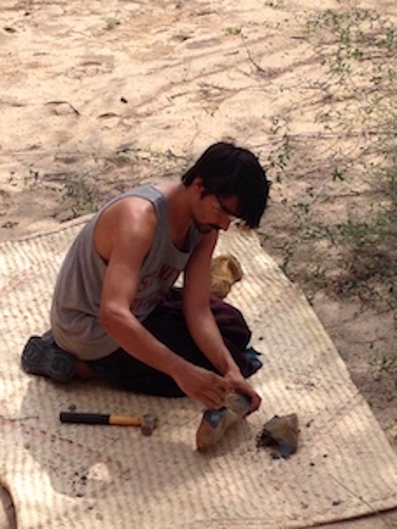Student Evan Wilson breaking experimental rocks in Turkana